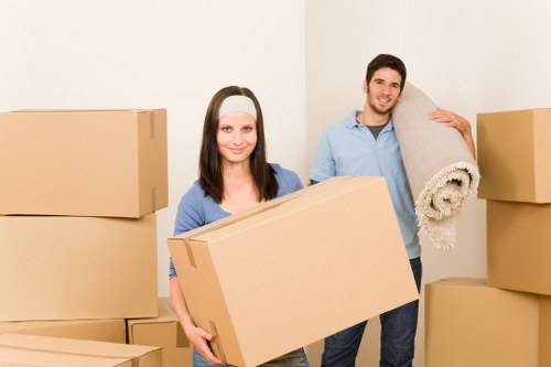 Professional movers handling furniture in a Stockwell apartment building