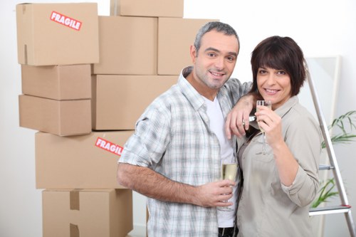 Movers carrying furniture through a Stockwell commercial property entrance