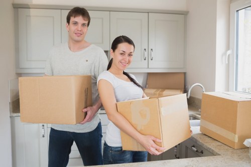 Local office movers handling desks and equipment in a Stockwell building